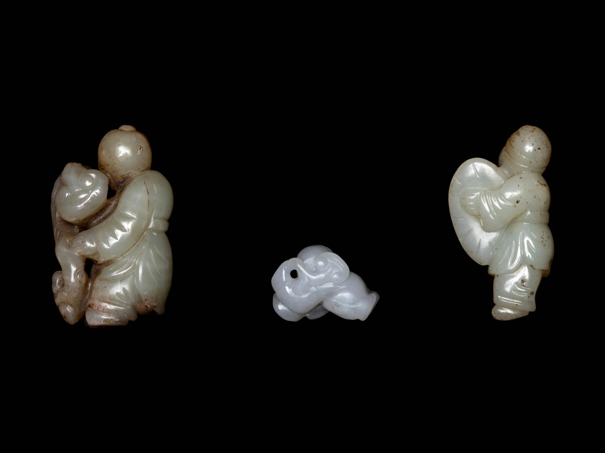 Three Chinese Celadon and White Jade Carved Figures of Boys