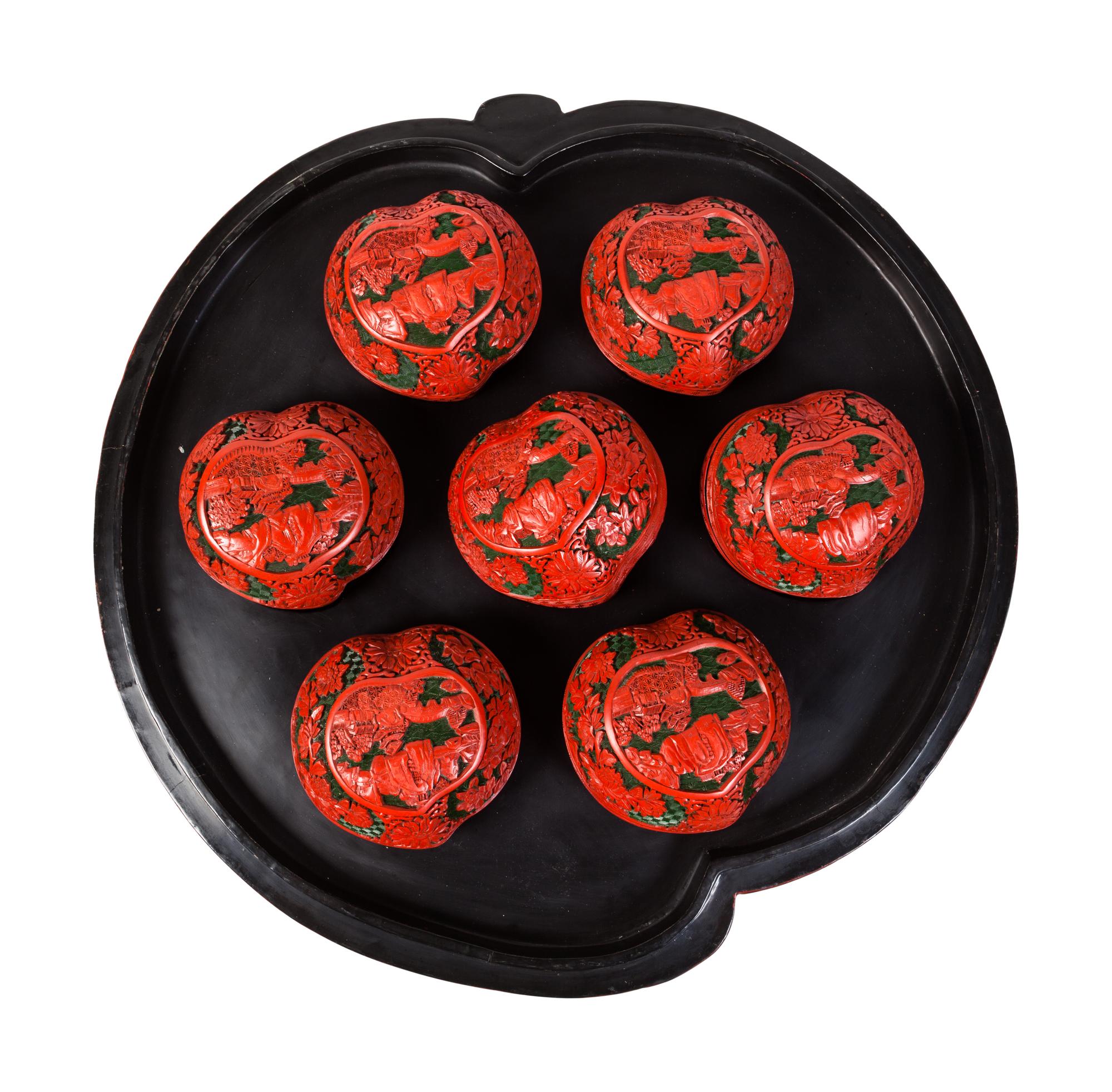 A Set of Chinese Export Carved Red Lacquer "Peach" Nesting Boxes and a Stand