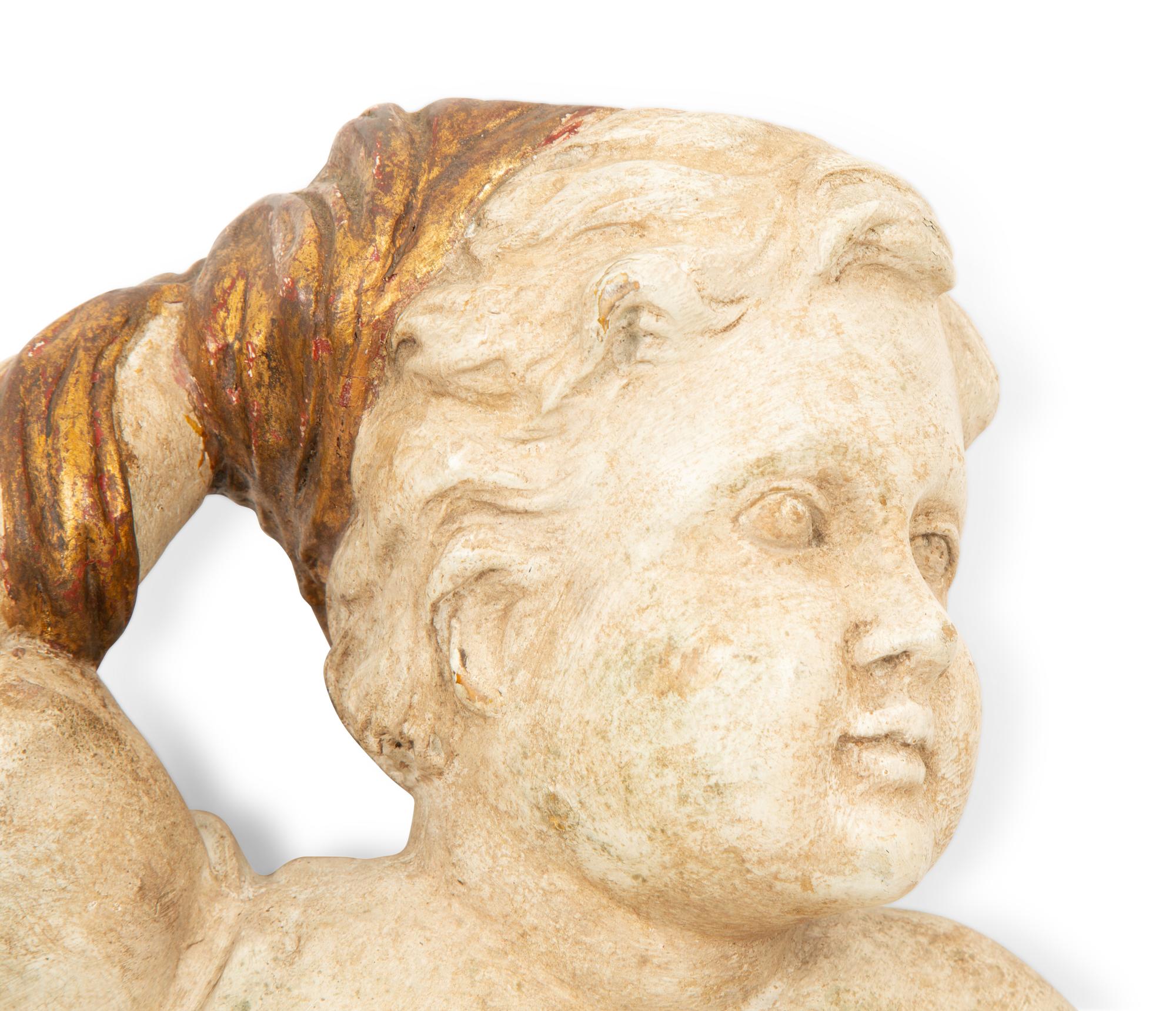 A Pair of Italian Carved, Painted and Parcel Gilt Putti
