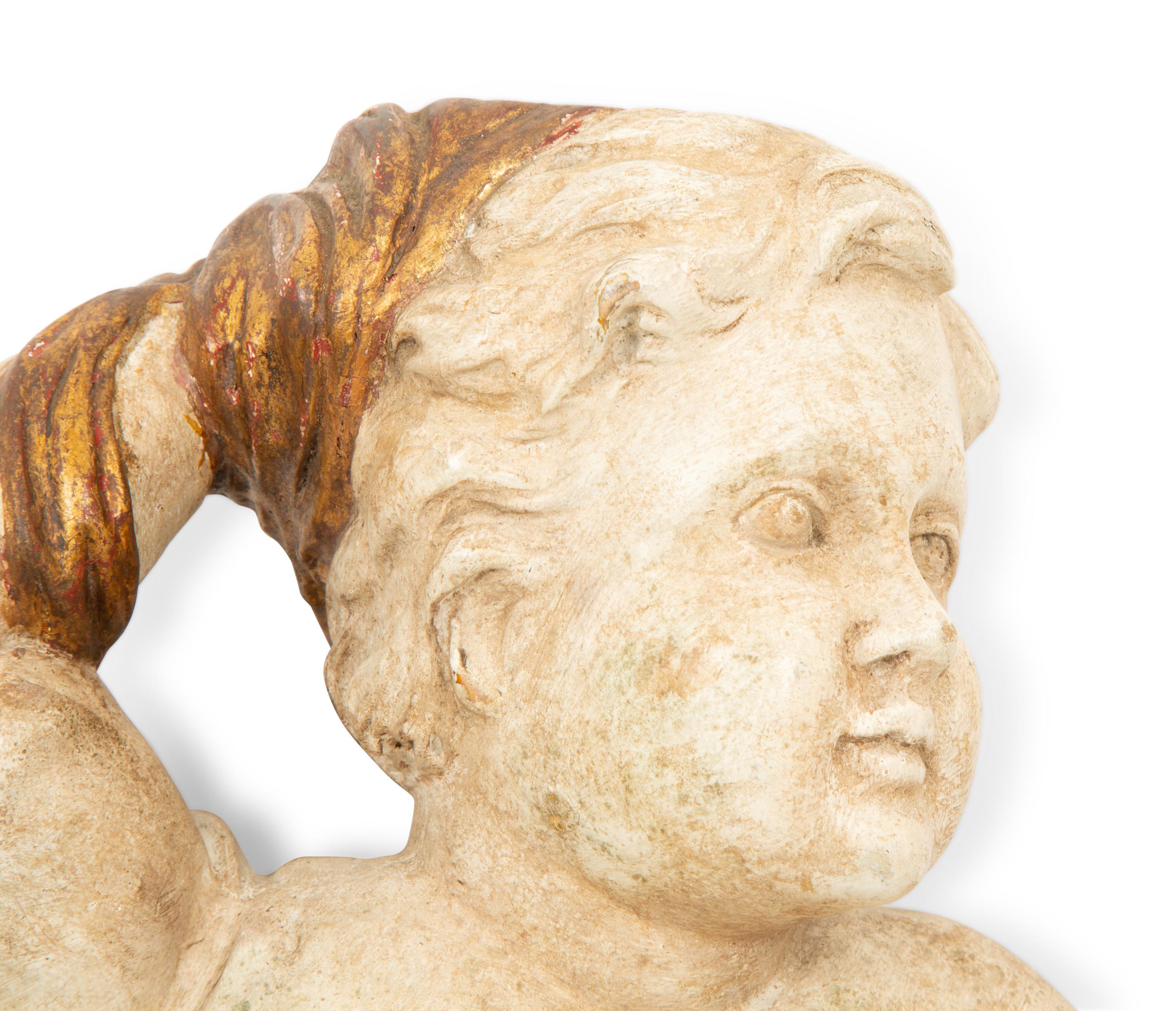 A Pair of Italian Carved, Painted and Parcel Gilt Putti