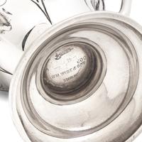 An Art Nouveau Three-Piece Sterling Silver Floral Cast and Repousse Coffee Service