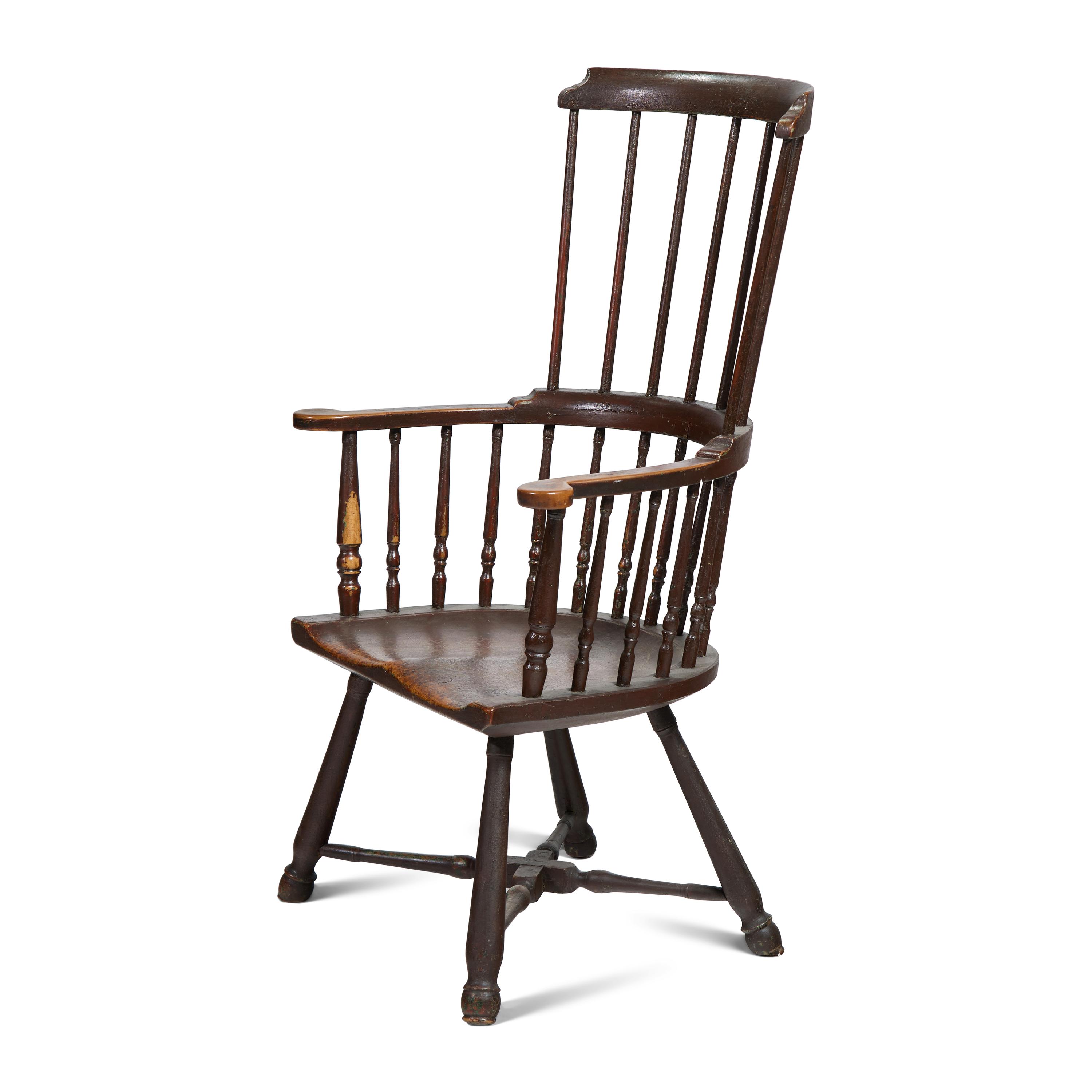 A Turned and Black-Painted Comb-Back Windsor Armchair