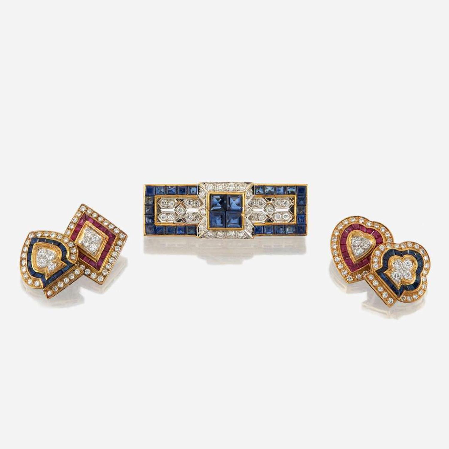 A gold, sapphire, and diamond brooch with similar cufflinks