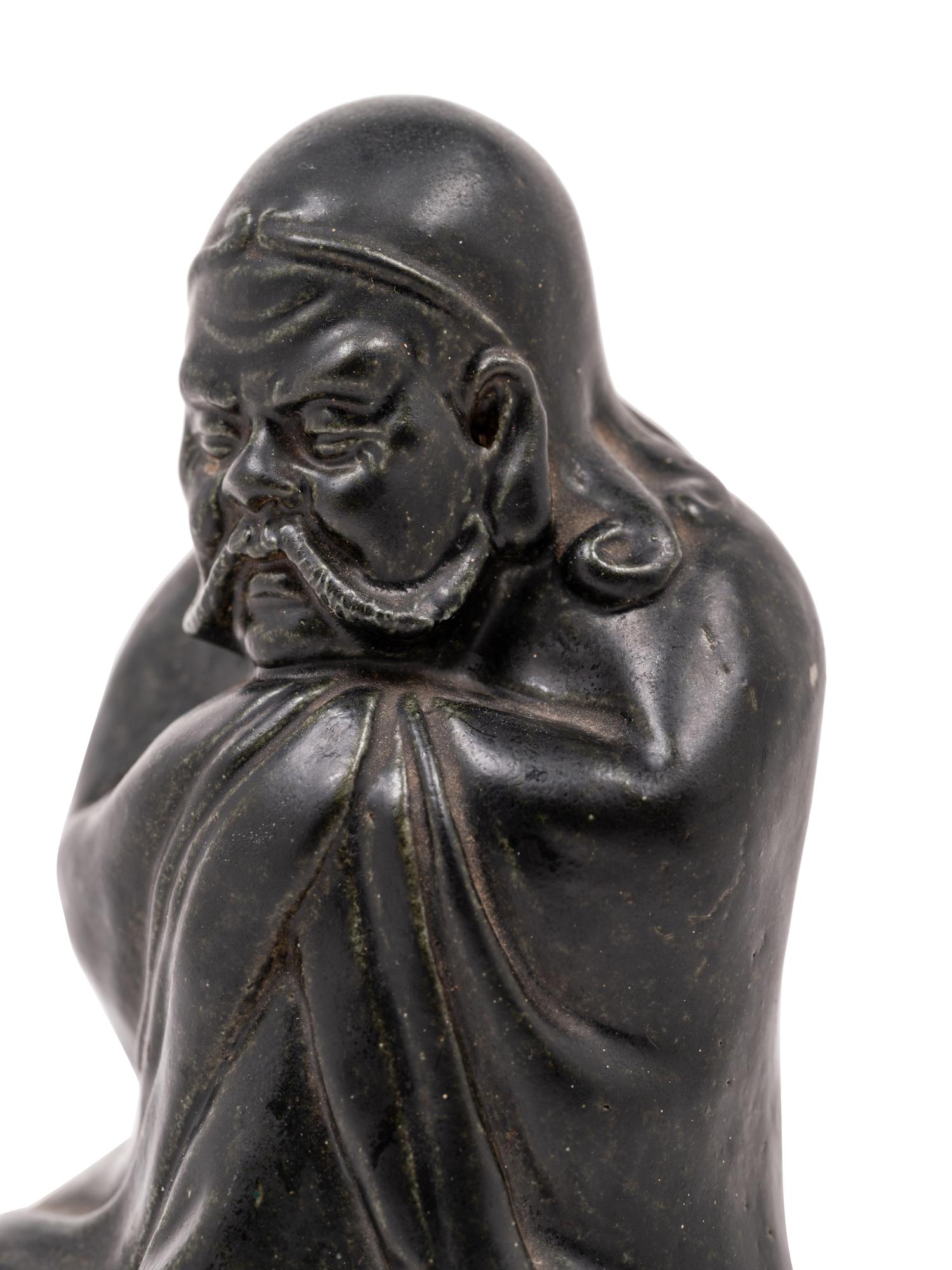 A Chinese Black Glazed Porcelain Figure of Seated Damo