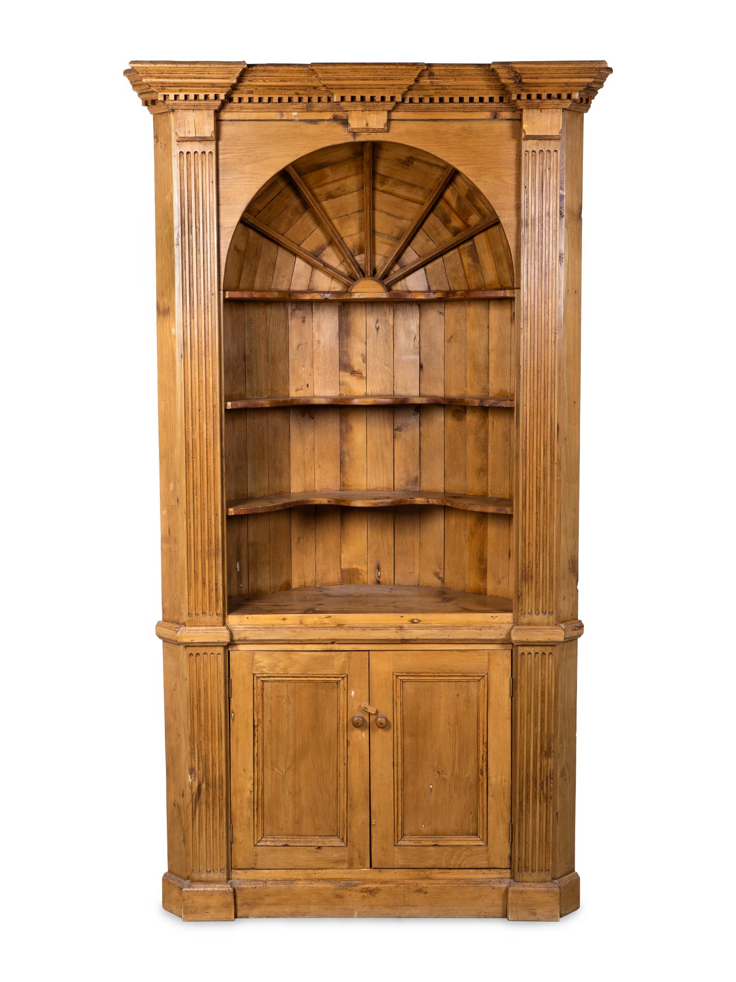 A George III Style Carved Pine Corner Cupboard