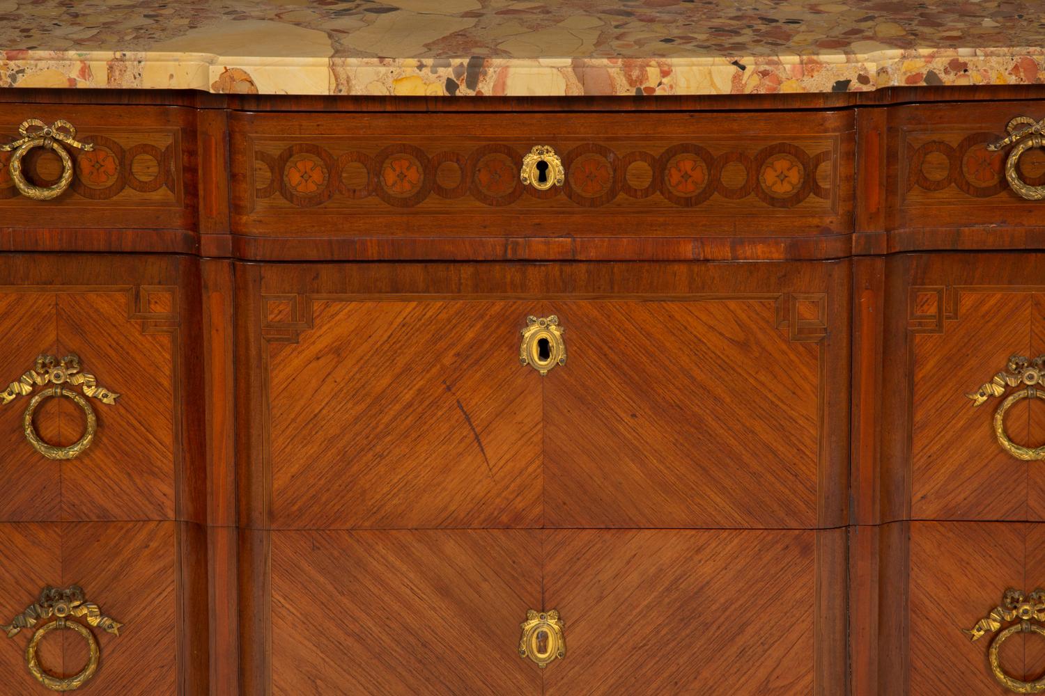A French Gilt Metal Mounted Mahogany and Kingwood Marquetry Marble-Top Commode