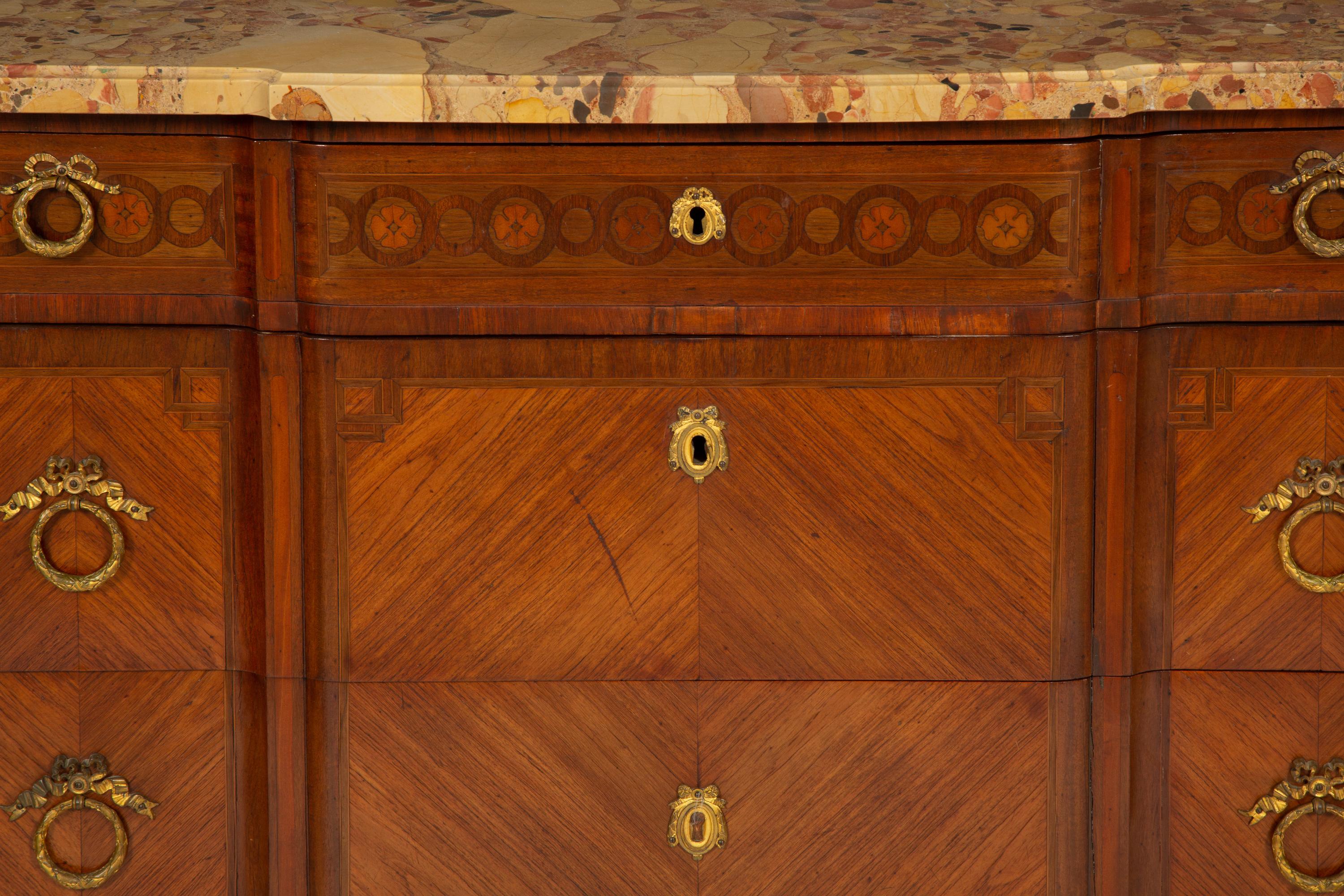 A French Gilt Metal Mounted Mahogany and Kingwood Marquetry Marble-Top Commode