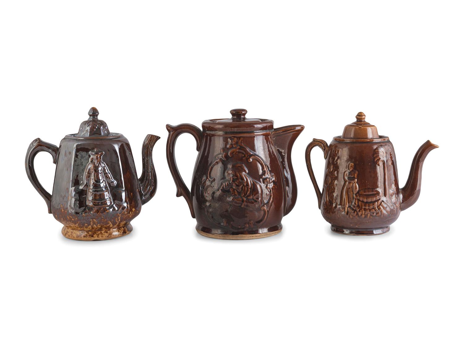 A Group of Molded Teapots and Jugs in Rockingham Glaze