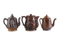 A Group of Molded Teapots and Jugs in Rockingham Glaze