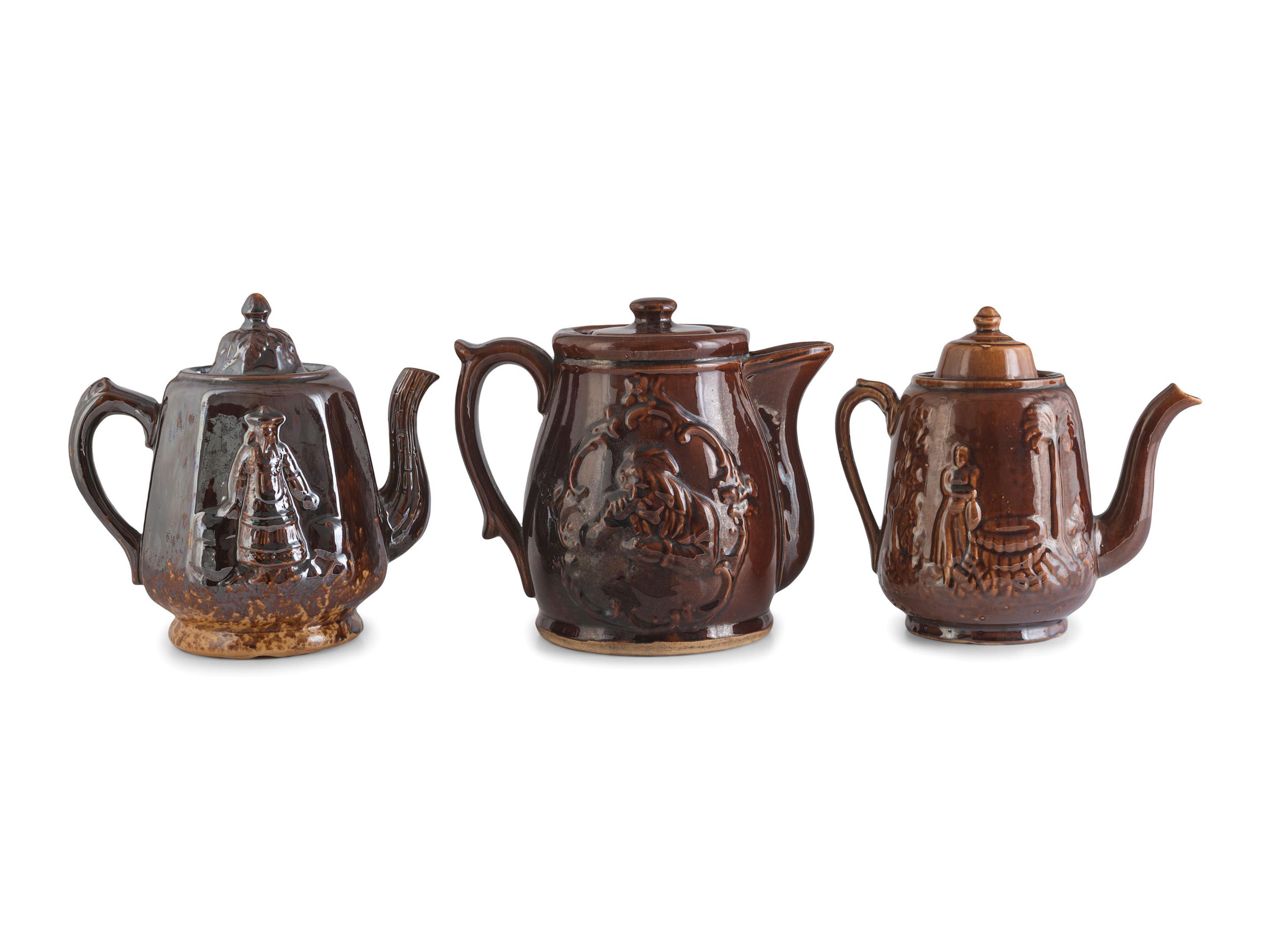 A Group of Molded Teapots and Jugs in Rockingham Glaze