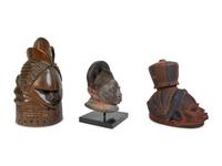 A Group of Three Helmet Masks from Tribes of West Africa — 20TH CENTURY