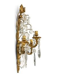A Pair of Louis XVI Style Gilt Bronze and Cut Glass Three-Light Sconces