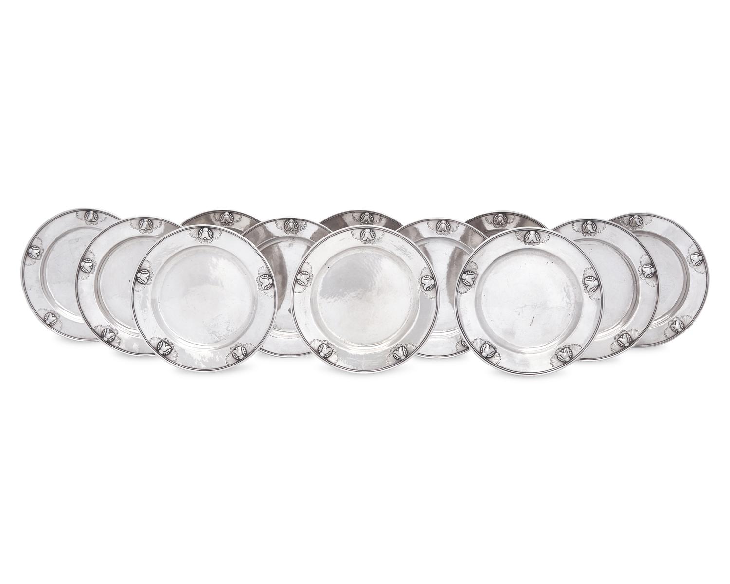 A Set of Twelve Georg Jensen Silver Bread Plates