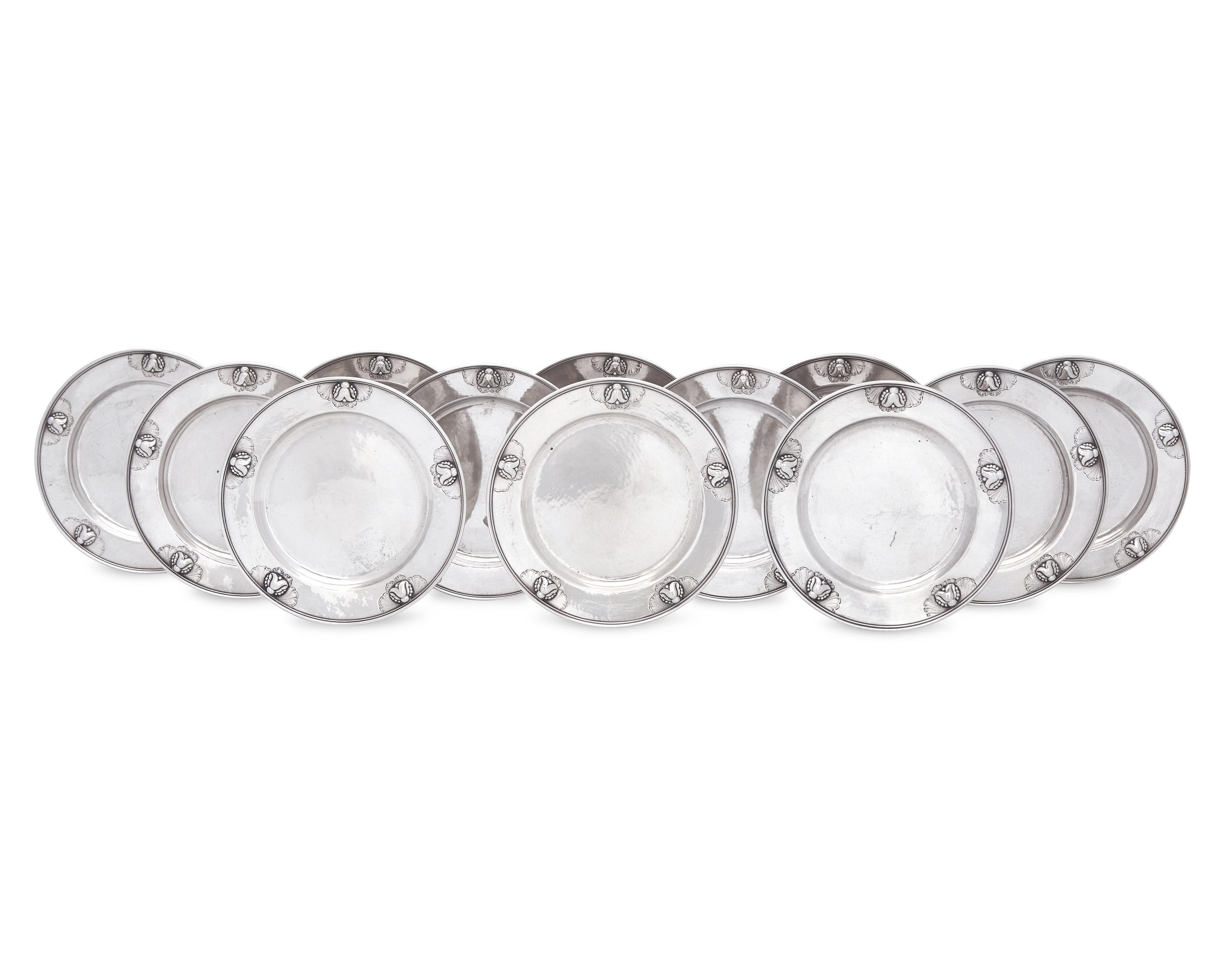A Set of Twelve Georg Jensen Silver Bread Plates