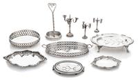 A Collection of English Silver Serving Trays, Various Makers, comprising a two-handled tray with a pierced gallery and centered by a co