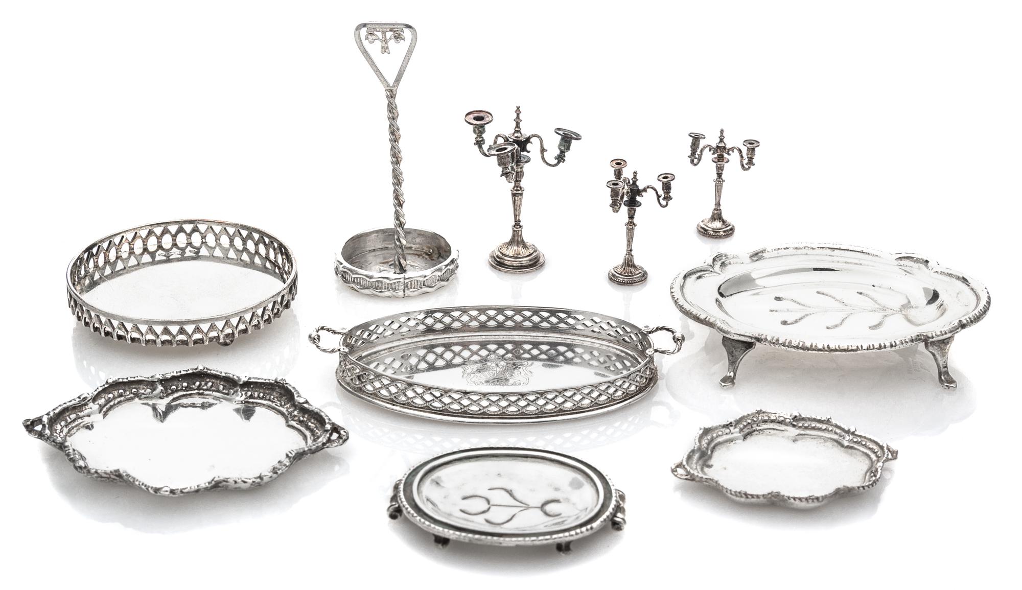 A Collection of English Silver Serving Trays, Various Makers, comprising a two-handled tray with a pierced gallery and centered by a co