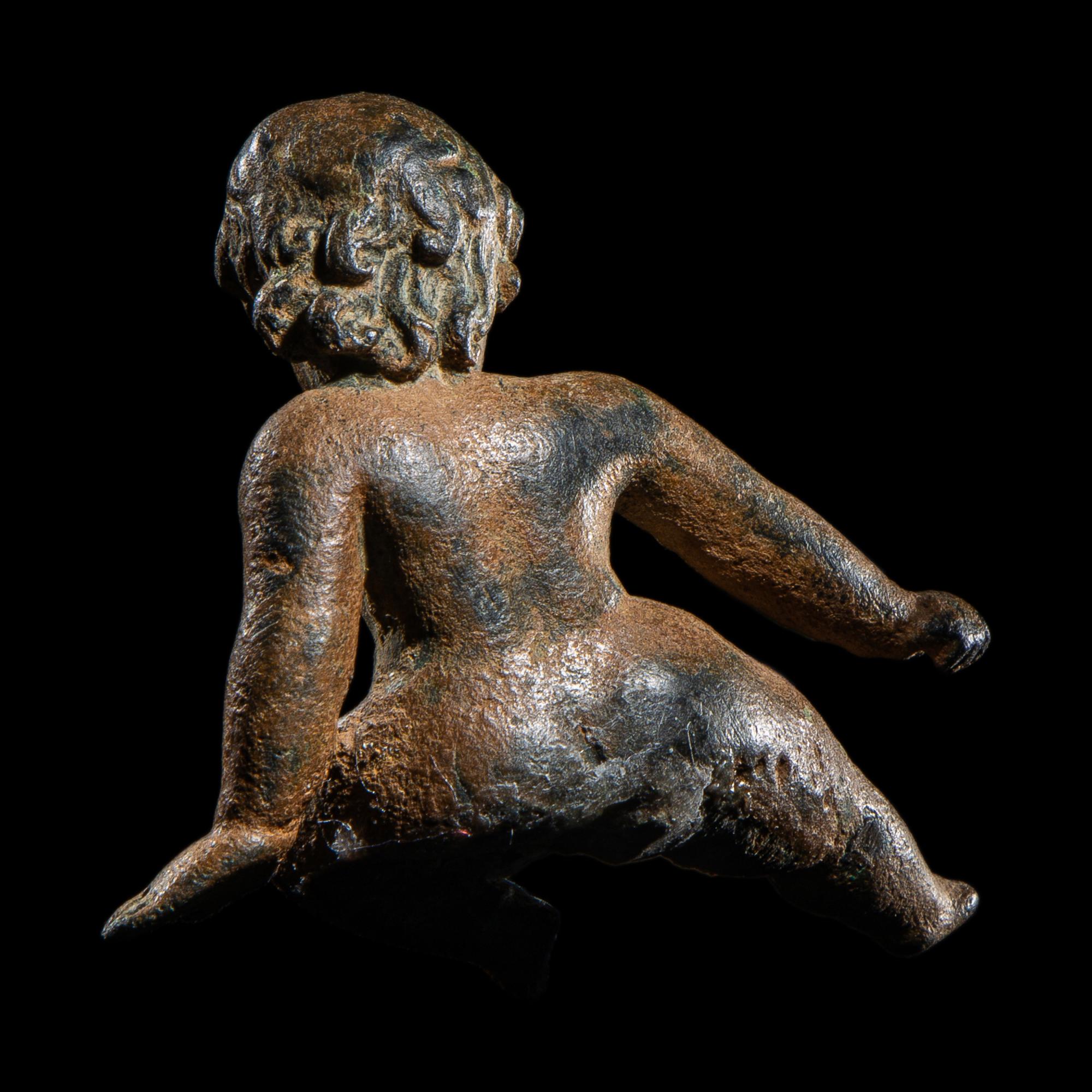 A Roman Bronze Seated Child