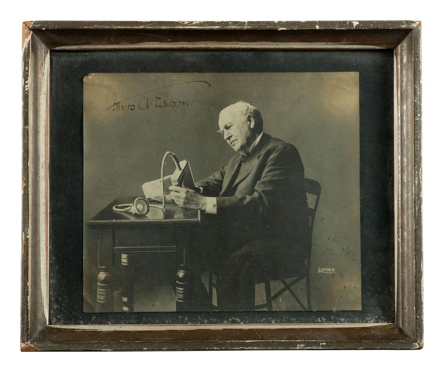 [EDISON, Thomas (1847-1931)]. LUEDER, Lewis, photographer. Portrait of Thomas Edison with an electric mine lamp, signed by Edison. Ca 1923.
