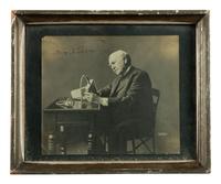 [EDISON, Thomas (1847-1931)]. LUEDER, Lewis, photographer. Portrait of Thomas Edison with an electric mine lamp, signed by Edison. Ca 1923.