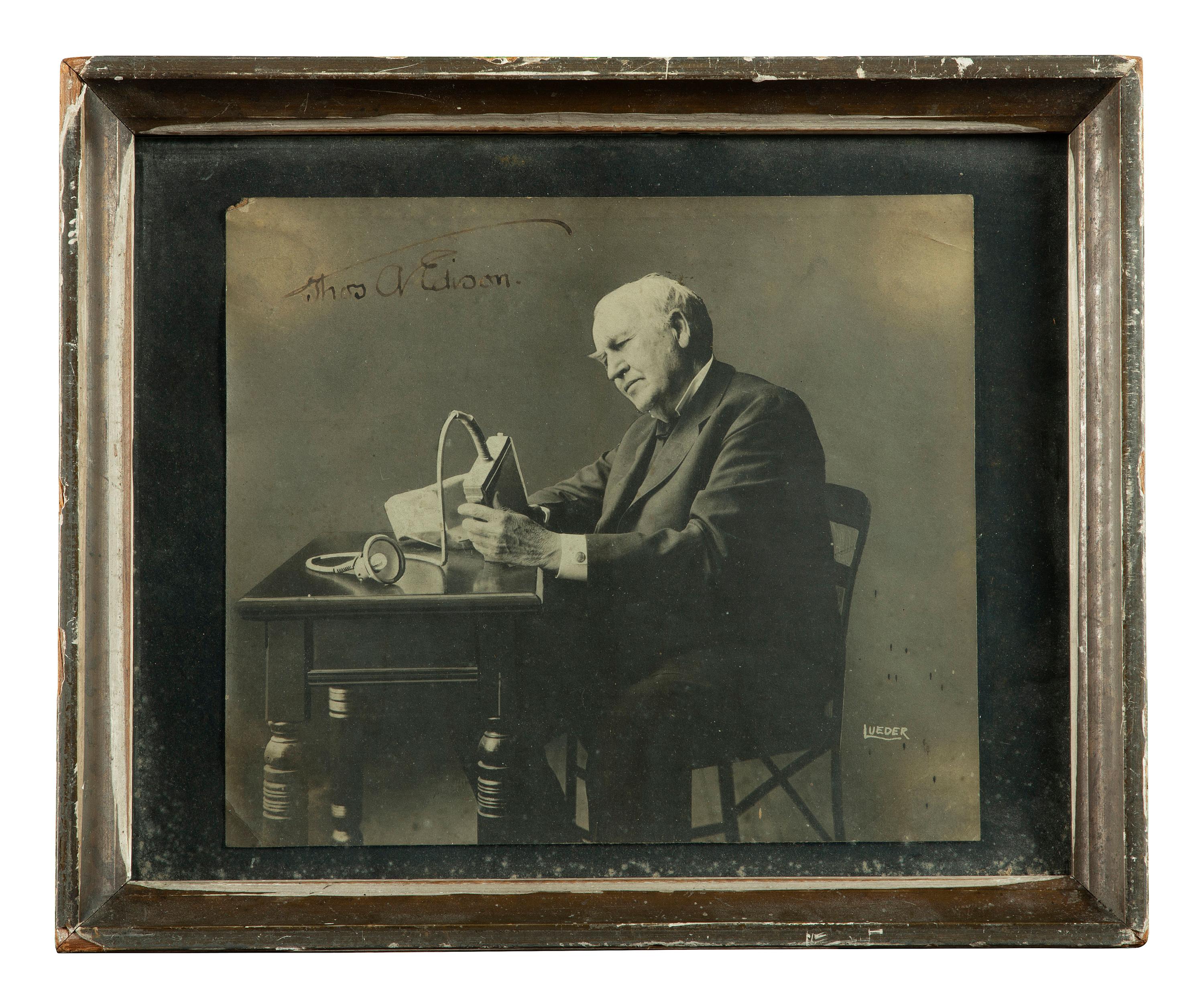[EDISON, Thomas (1847-1931)]. LUEDER, Lewis, photographer. Portrait of Thomas Edison with an electric mine lamp, signed by Edison. Ca 1923.