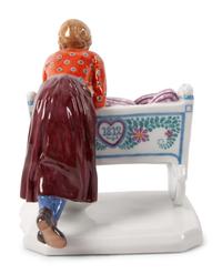 A Meissen Porcelain Figural Group of a Woman with Cradle