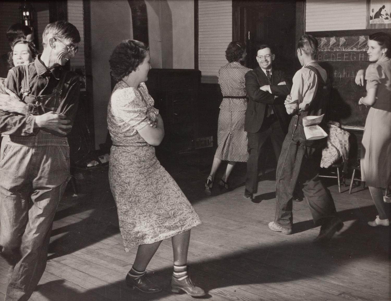 A group of five photographs ( A member of the Wilkins Family Making Biscuits , 1939; Post Office in Blizzard, Aspen, CO , 1941; Negro (Black) Man Entering Movie Theater by Colored Entrance, Belzoni, Miss., 1939; Crossroad and General Store (Mosquito Crossing) Near Greensboro, GA, 1939 (printed 1981); Recreation Evening at Community School Under Direction of WPA Recreational Supervisor (in suit and tie) Coffee County, Alabama, 1939)