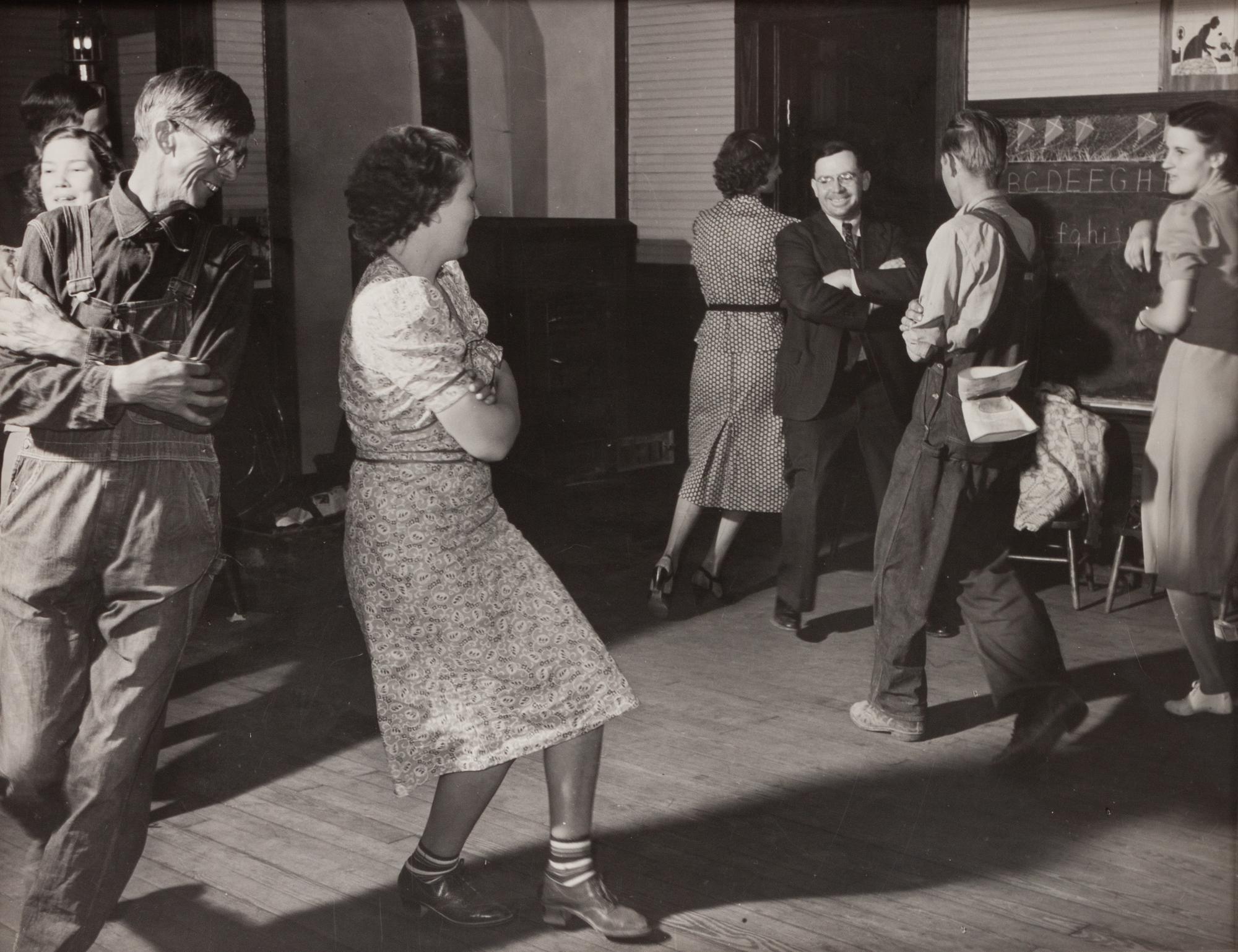 A group of five photographs ( A member of the Wilkins Family Making Biscuits , 1939; Post Office in Blizzard, Aspen, CO , 1941; Negro (Black) Man Entering Movie Theater by Colored Entrance, Belzoni, Miss., 1939; Crossroad and General Store (Mosquito Crossing) Near Greensboro, GA, 1939 (printed 1981); Recreation Evening at Community School Under Direction of WPA Recreational Supervisor (in suit and tie) Coffee County, Alabama, 1939)