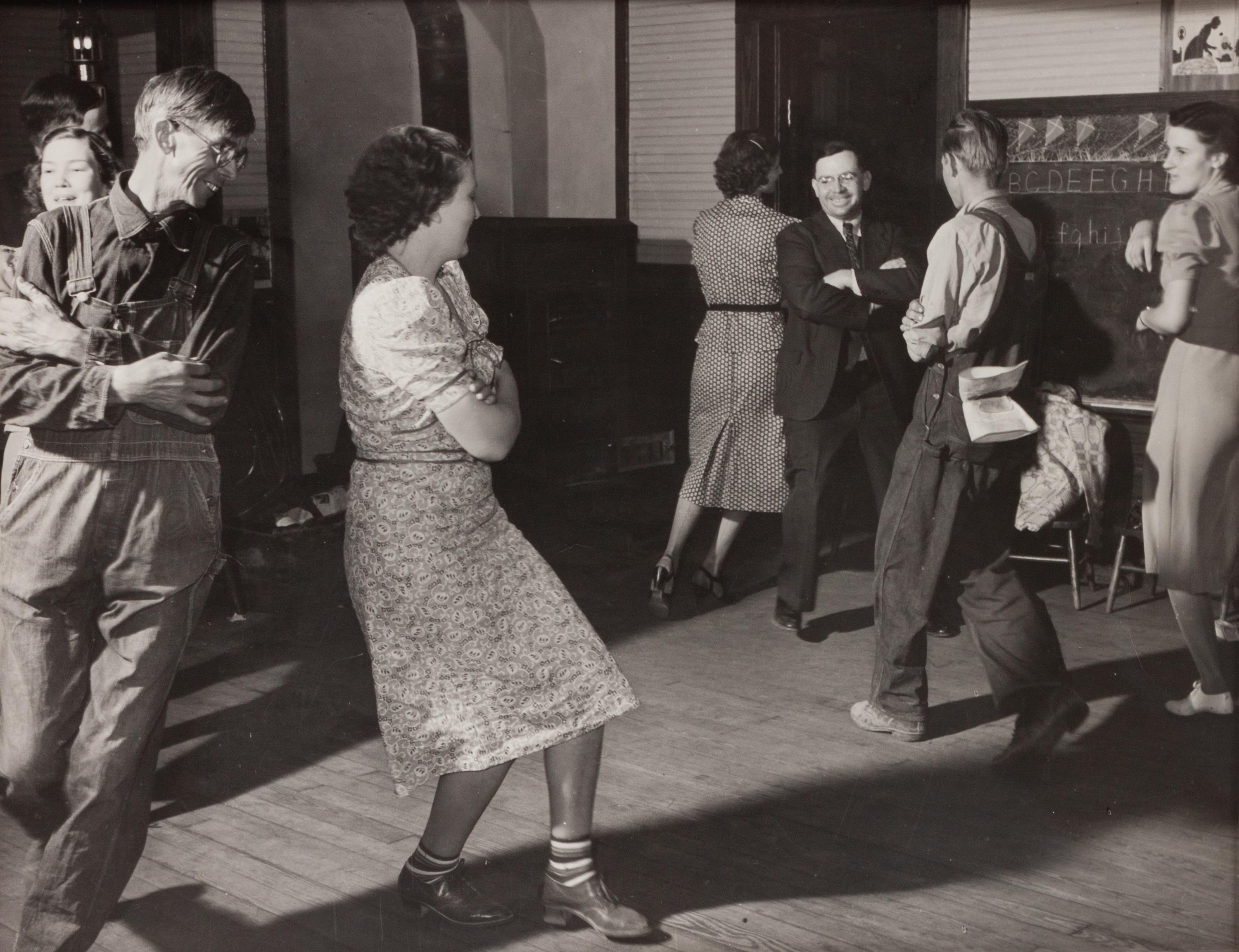 A group of five photographs ( A member of the Wilkins Family Making Biscuits , 1939; Post Office in Blizzard, Aspen, CO , 1941; Negro (Black) Man Entering Movie Theater by Colored Entrance, Belzoni, Miss., 1939; Crossroad and General Store (Mosquito Crossing) Near Greensboro, GA, 1939 (printed 1981); Recreation Evening at Community School Under Direction of WPA Recreational Supervisor (in suit and tie) Coffee County, Alabama, 1939)