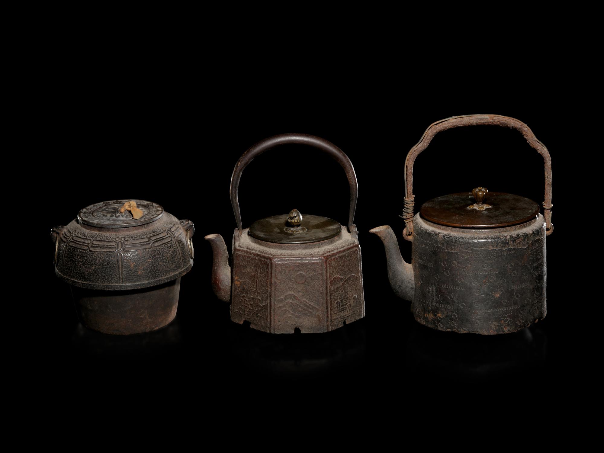 Seven Japanese Cast Iron Teapots, Tetsubin, and Burner
