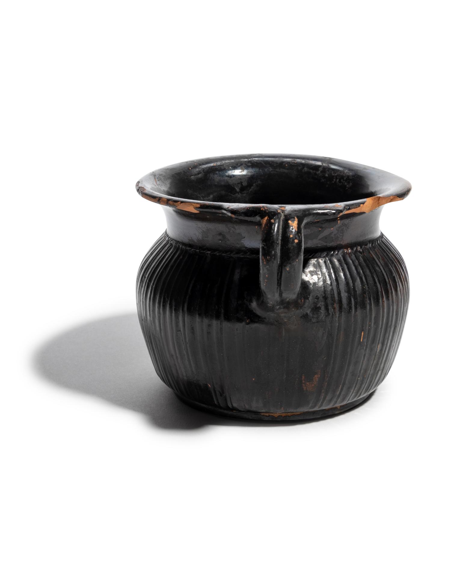 A Greek Black-Glazed Ribbed Mug