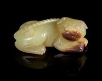 A Yellow Jade Figure of a Recumbent Dog Length 2 1/2 inches.