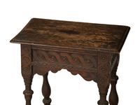 A Jacobean Style Carved Oak Writing Table and a Similar Stool with Flip Top