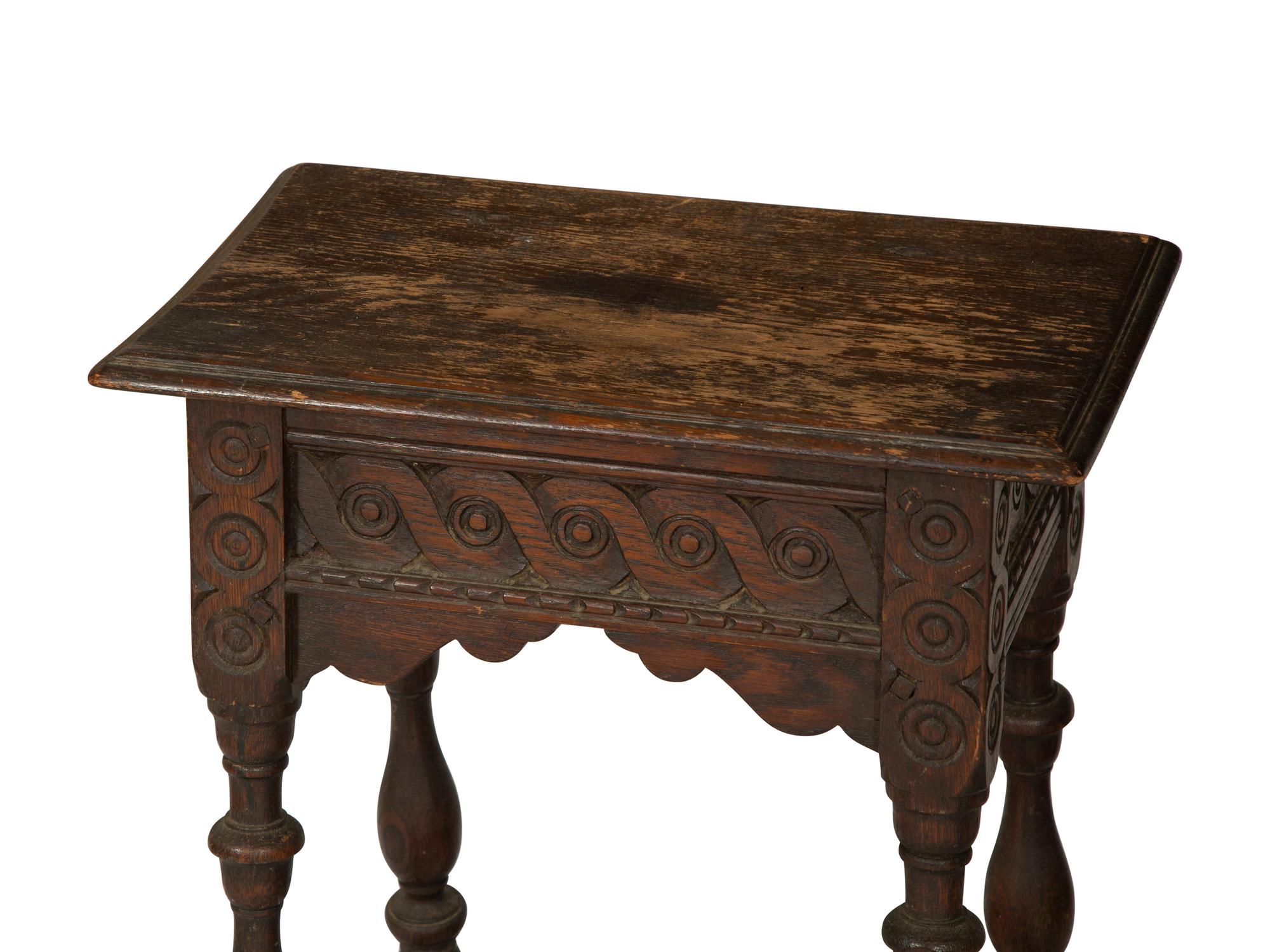 A Jacobean Style Carved Oak Writing Table and a Similar Stool with Flip Top