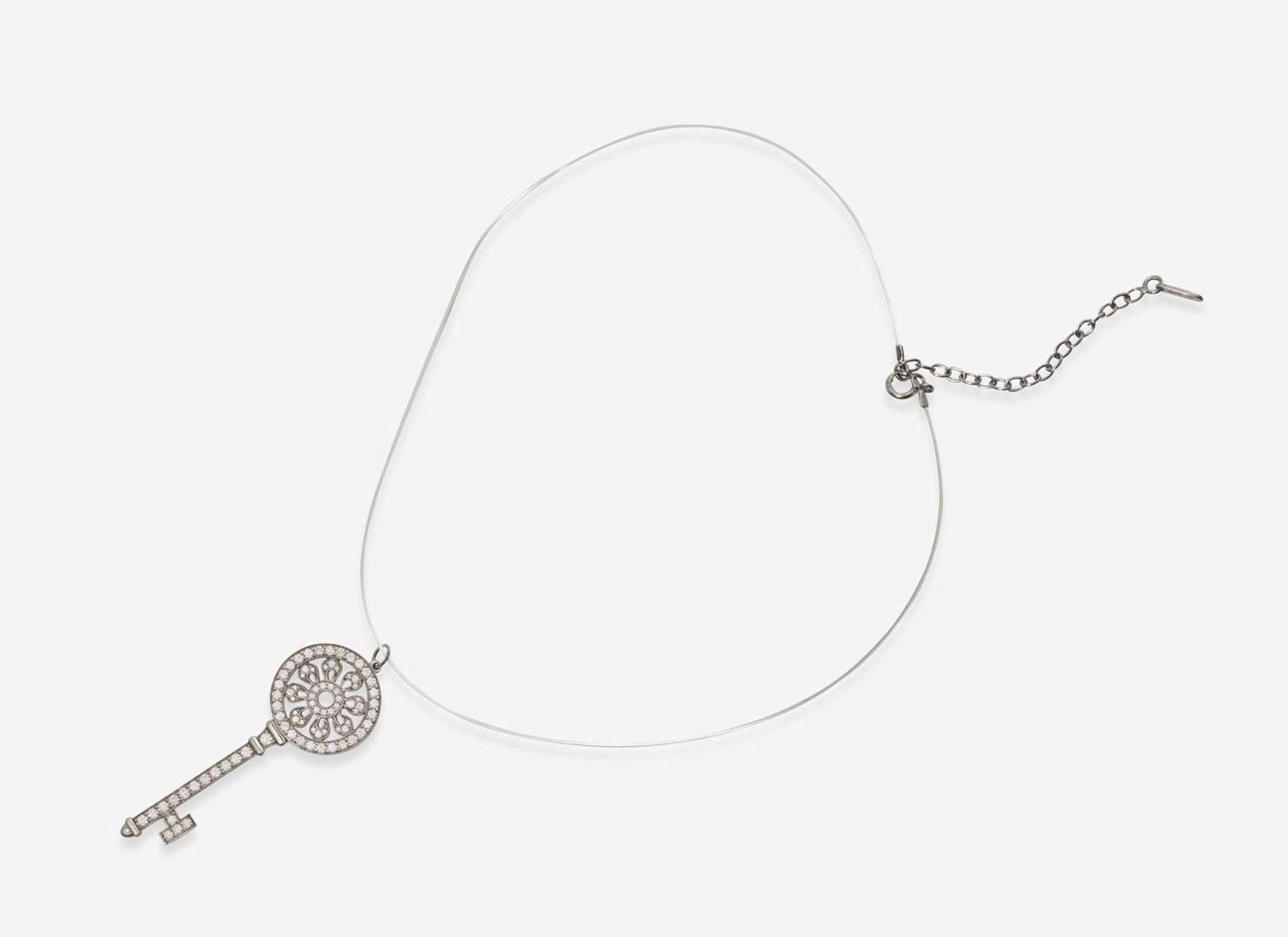 A Platinum and Diamond Tiffany & Co. Petals Key Pendant on a Sterling Silver Lalique Cord