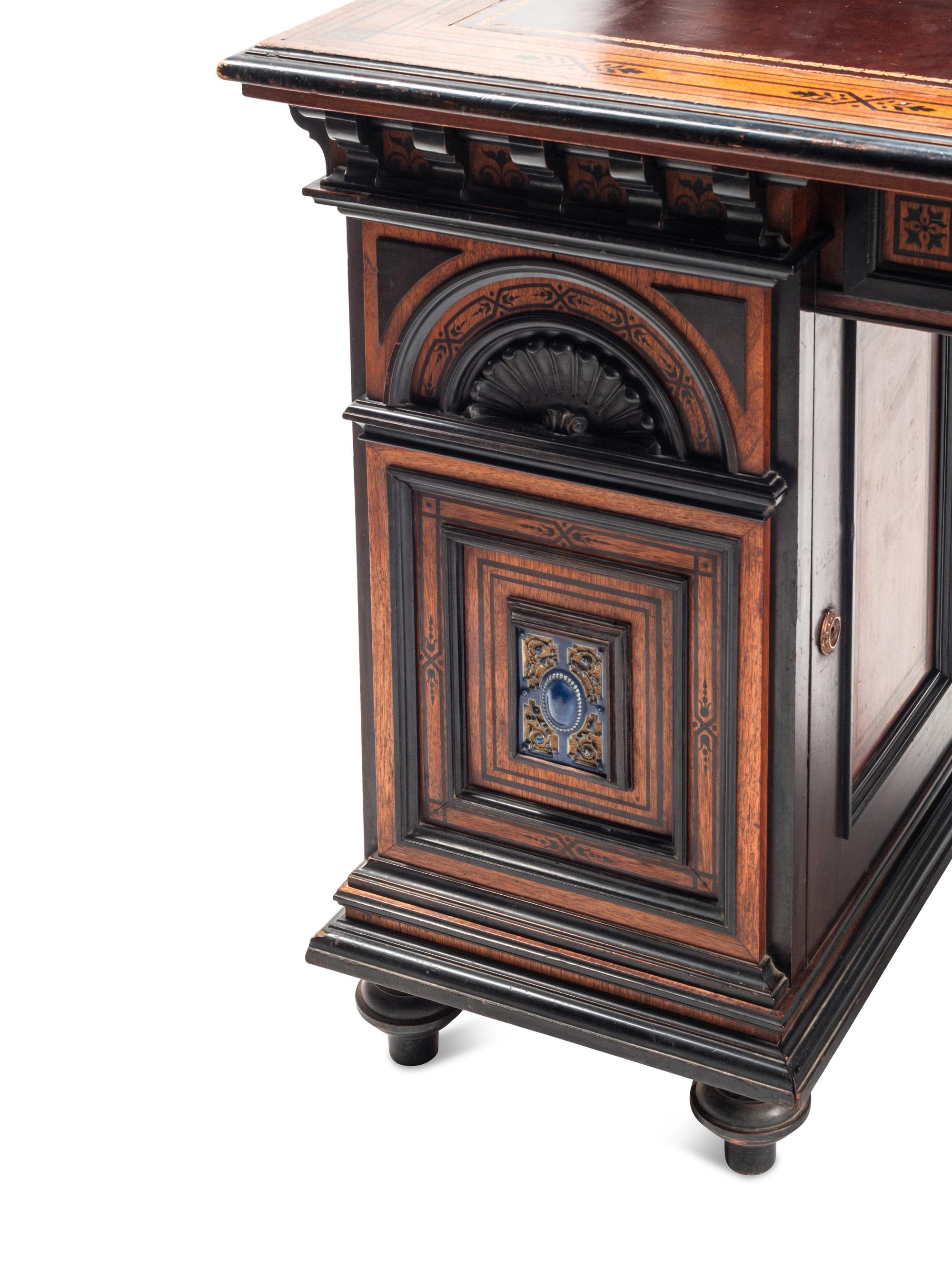 An English Aesthetic Movement Walnut, Part Ebonized and Glazed Earthenware Plaque-Inset Bureau Cabinet