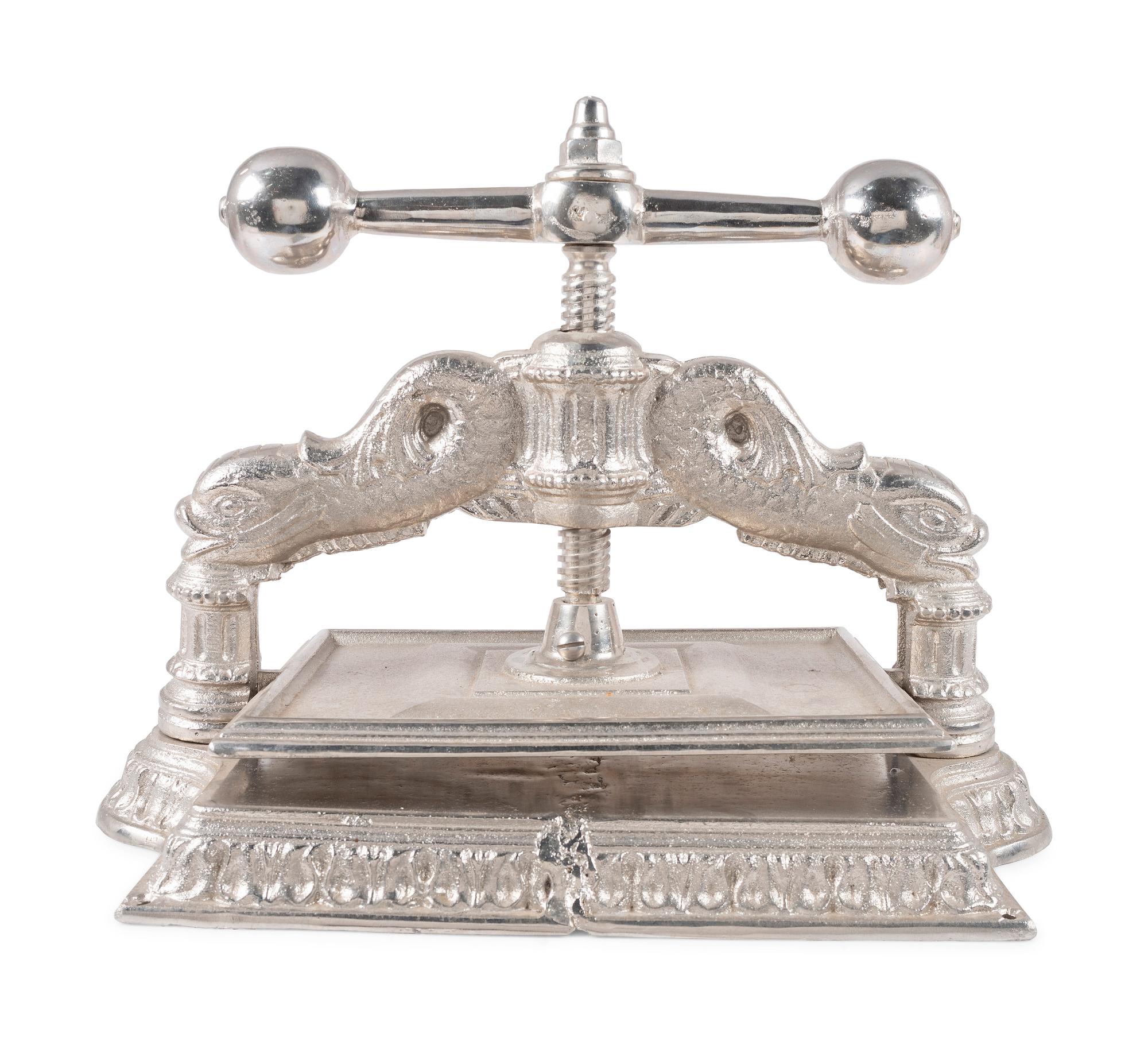 A Dolphin Form Silvered Metal Book Press