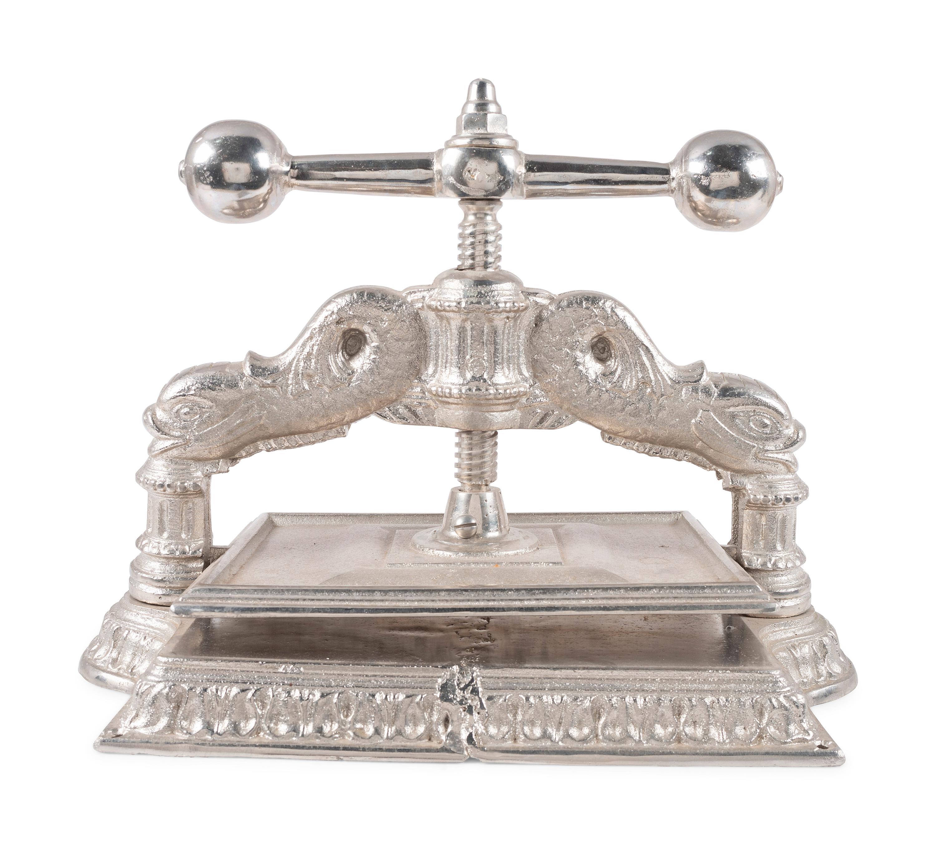A Dolphin Form Silvered Metal Book Press