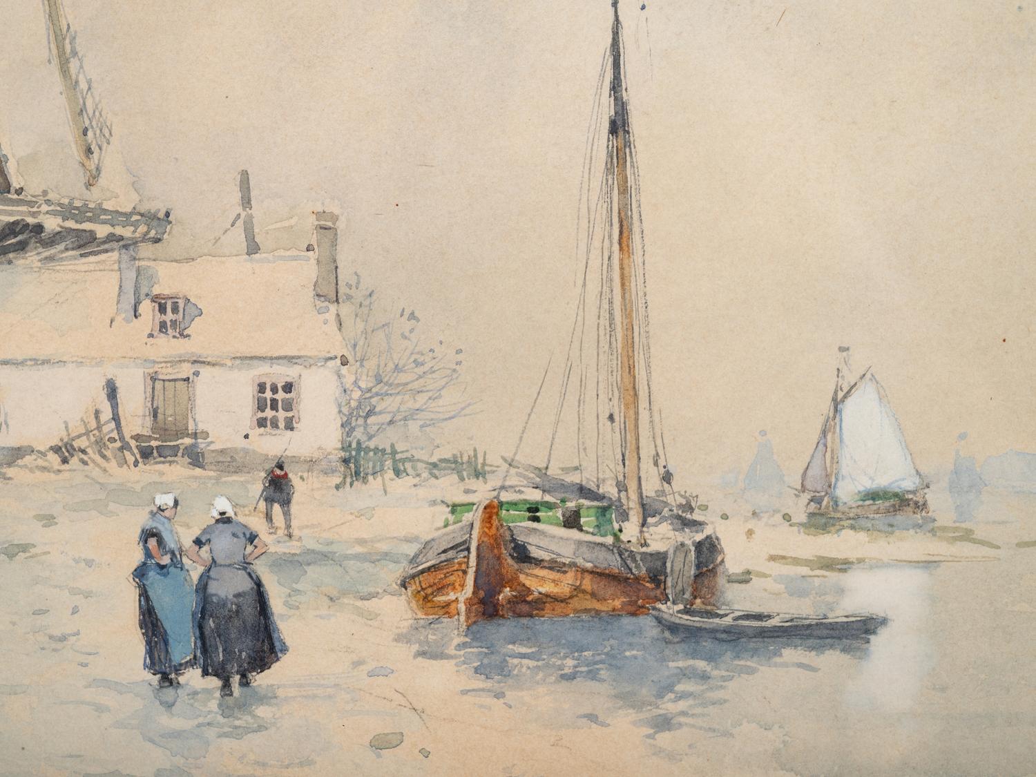 Windmill near a river with figures in the snow