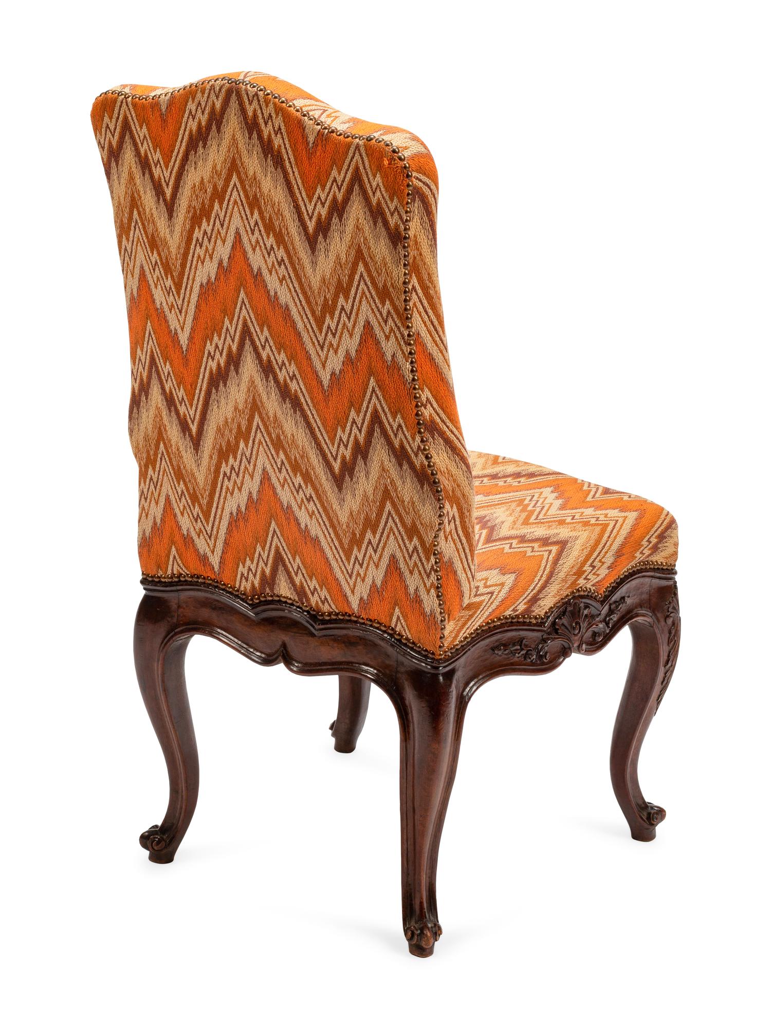 A Set of Eight Continental Carved Walnut Dining Chairs