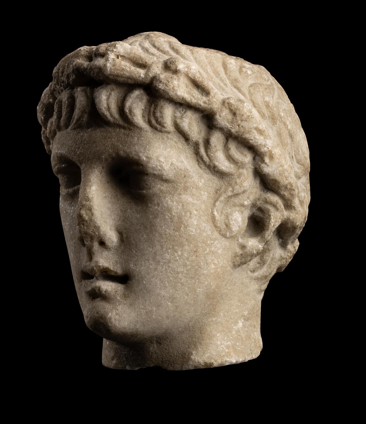 A Roman Marble Head of a Youth with Laurel Wreath