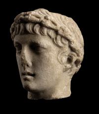A Roman Marble Head of a Youth with Laurel Wreath