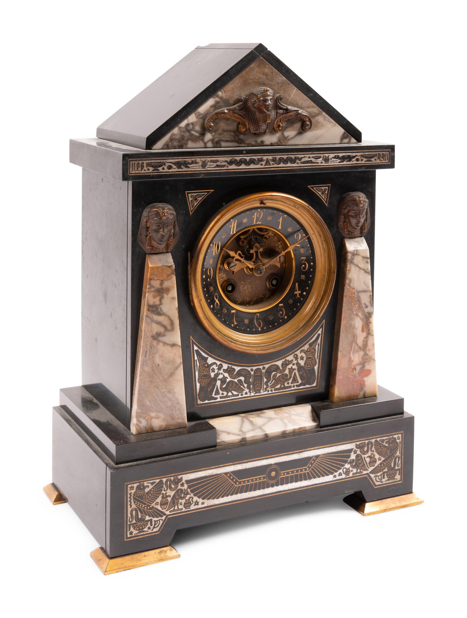 An Egyptian Revival Marble and Patinated Bronze Mantel Clock Garniture