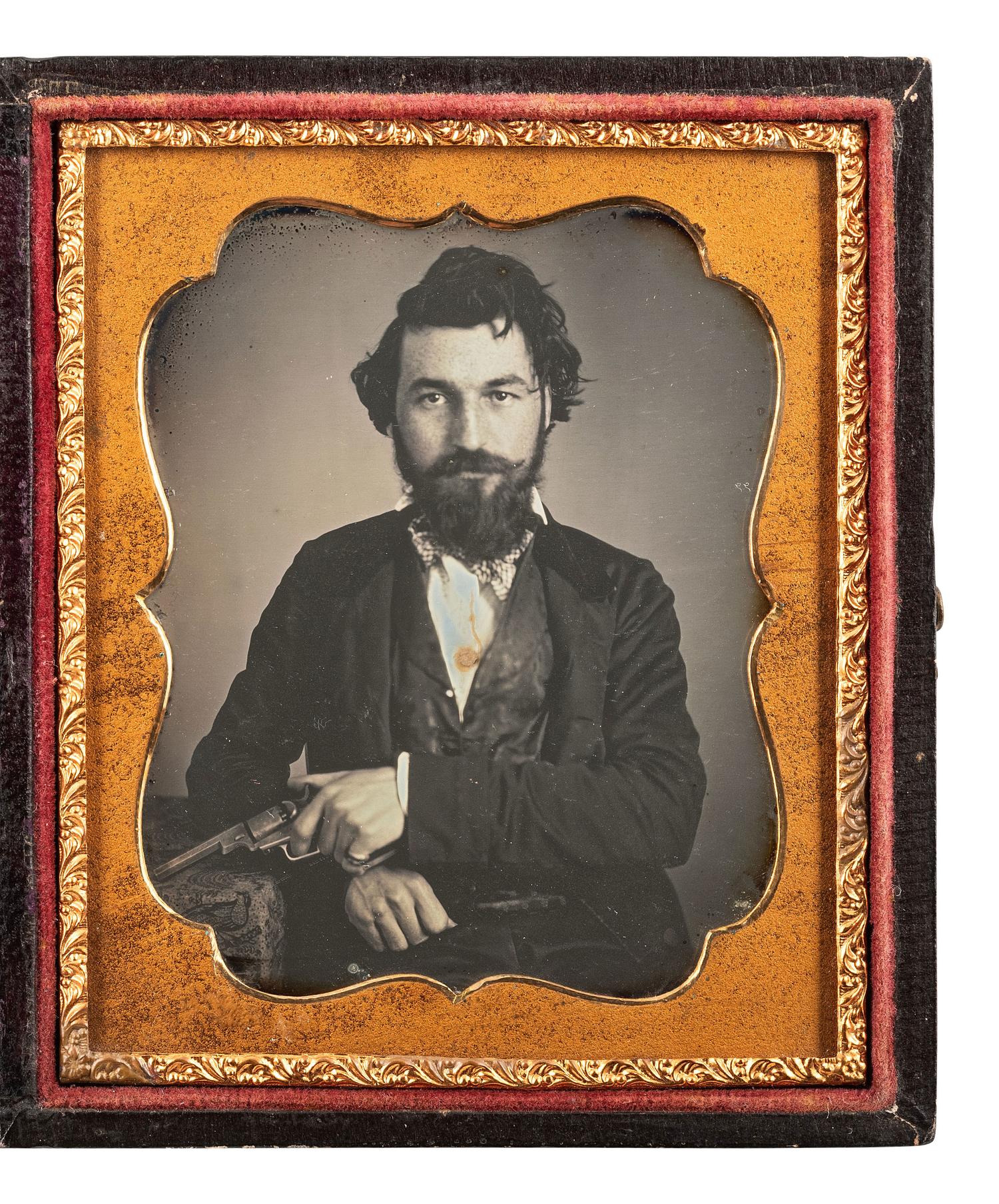 [MINING - EARLY PHOTOGRAPHY]. Sixth plate daguerreotype of a likely California gent holding a Colt "Baby Dragoon" and wearing a gold nugget stickpin.