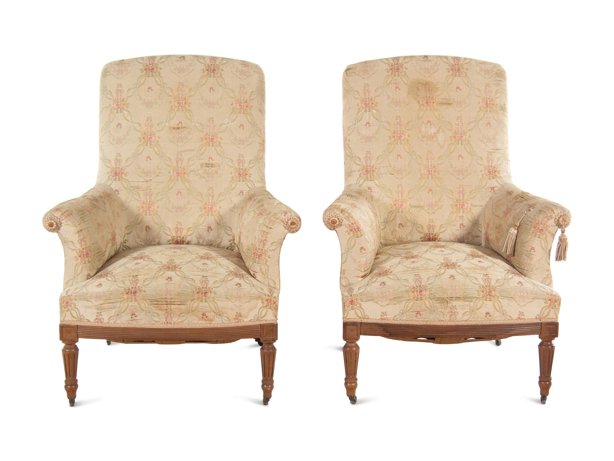 A Pair of Louis XVI Style Walnut Easy Chairs