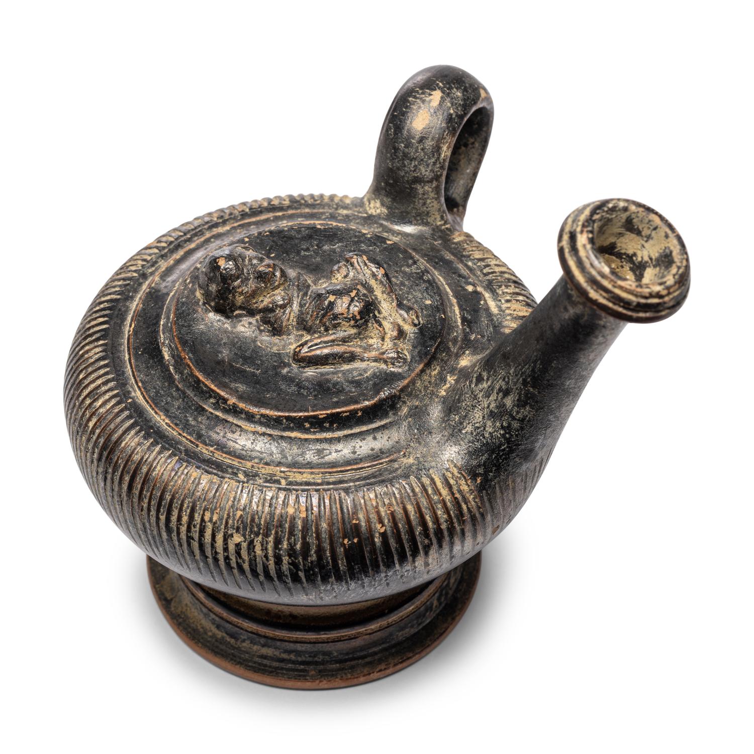 A Campanian Black-Glazed Guttus with a Grotesque
