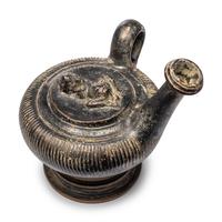 A Campanian Black-Glazed Guttus with a Grotesque