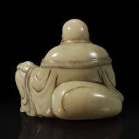 A Chinese carved soapstone figure of a seated Budai 寿山石雕布袋和尚