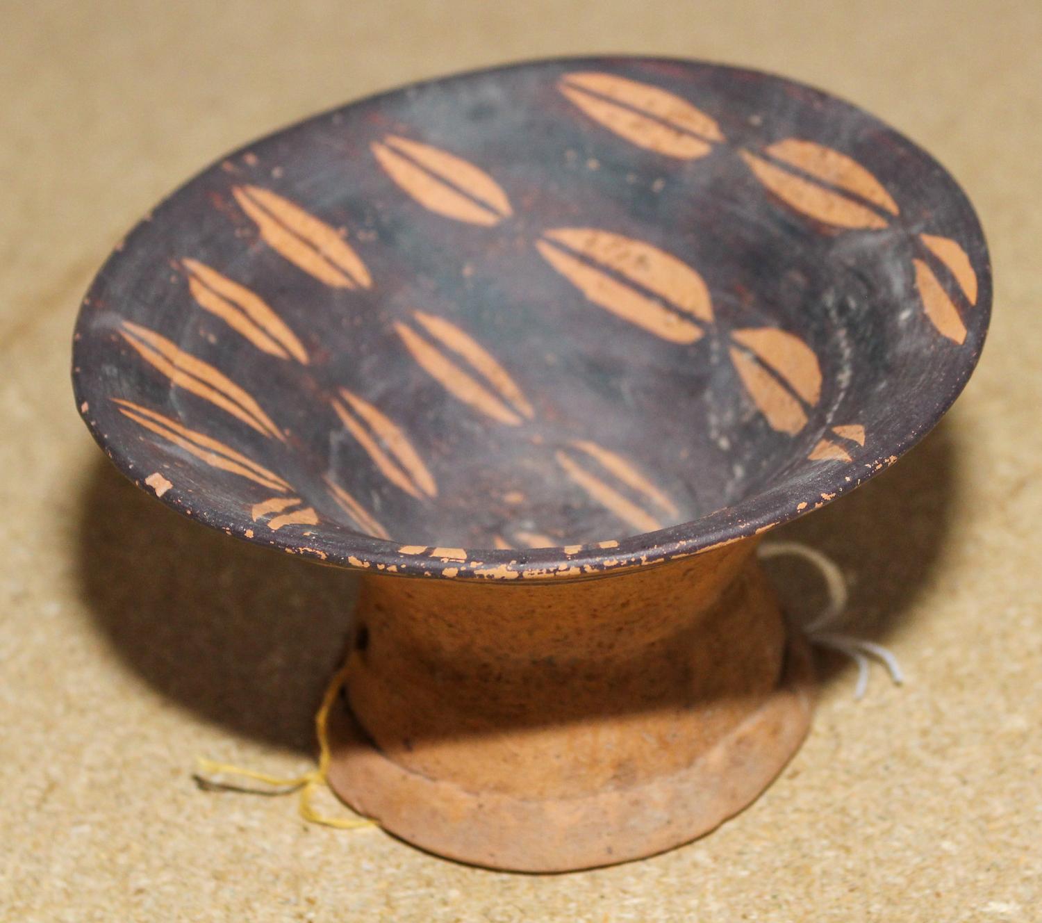 A Neolithic Pottery Vessel Height 3 1/8 x diameter 5 1/2 inches.
