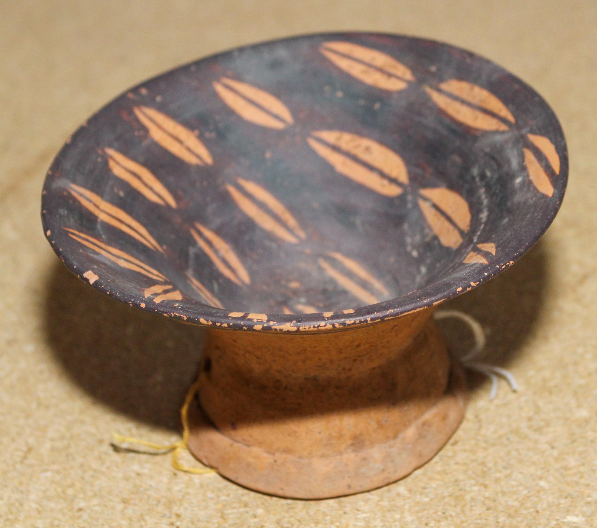 A Neolithic Pottery Vessel Height 3 1/8 x diameter 5 1/2 inches.