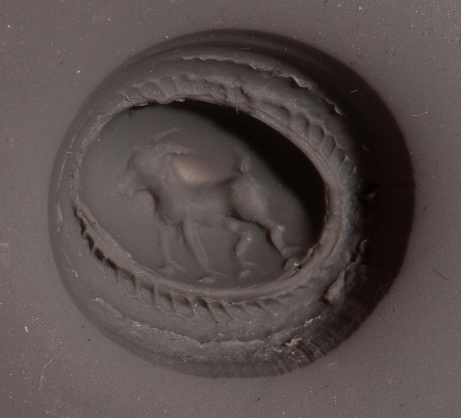 A Roman Gilt-Silver and Garnet Finger Ring with a Ram